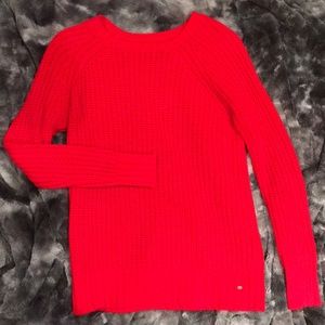 Bright red sweater slightly worn